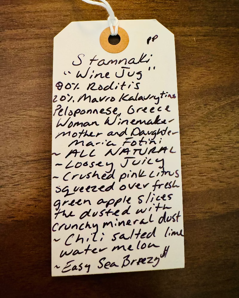 Handwritten tag on a wooden surface with product description