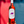 Bottle of red wine with a label held against a colorful background
