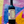Bottle of Negramaro wine held against a colorful abstract background