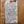 Handwritten tag on a wooden surface with product description and price.