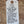 White tag with black text on a wooden surface