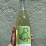 Bottle of Caprighorn with a green label held against a gray background