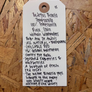 White tag with black text on a wooden background