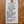 White tag with black text on a wooden surface