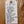 Handwritten tag on a wooden surface with product details.
