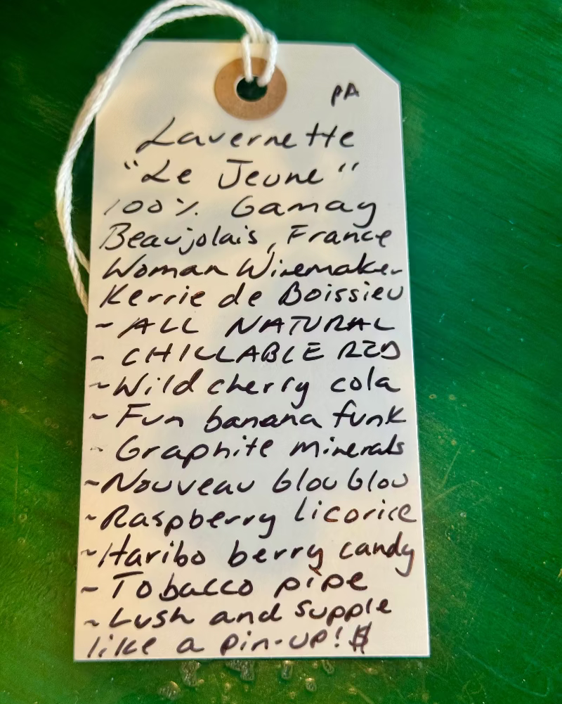 Handwritten tag on a green background with product description
