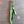 Corkscrew with green handle on a wooden surface