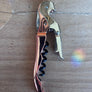 Metallic corkscrew on a wooden surface