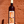 Bottle of 'Orange John Doe' wine held against a red brick wall.