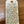 Handwritten tag with product description on a wooden surface