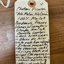 Handwritten wine label on a wooden surface