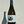 Bottle of wine held by a hand with a plain background