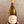 Bottle of Sauvignon wine held by a hand against a neutral background