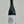 Wine bottle with a label held by a hand against a gray background