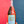 Bottle of 'Salty Skin' by Kiki held against a red and blue background