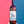 Wine bottle held against a red and blue background