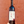 Wine bottle held in front of a red brick wall