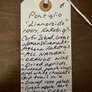 Handwritten wine label on a wooden surface