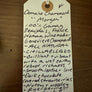 Handwritten wine label on a wooden surface