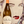 Bottle of Pouilly-Fumé wine held in front of a stylized portrait of a woman.