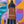 Bottle of Pinot Nero wine held in front of a colorful abstract background