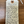 Handwritten tag on a wooden surface with wine information.