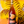 Bottle of wine held in front of a colorful abstract background