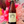 Bottle of 'Gut Feeling' beer held in front of decorative flowers