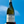Bottle of Petit Chablis wine held against a blue sky