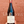 Bottle of Chateau de Lavernette Beaujolais-Villages 2021 held against a red brick wall.