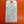 Handwritten tag on a red background with product description text.
