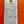 Handwritten wine label on a white tag against an orange background