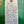Handwritten tag on a green background with wine description text