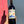 Bottle of Delta Cabernet Sauvignon wine held by a person against a blue and pink background