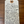 Handwritten tag with wine description on a wooden surface