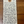 Handwritten tag on a wooden surface with product details.