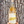 A hand holds a bottle of MianU wine against a textured tree trunk background. The bottle contains a golden-amber liquid and has a cream label with a yellow brushstroke design and the brand name 'Niman' in black script.