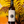 A hand holds a bottle of Mirabés 2025 Barolo red wine. The bottle has a cream-colored label with black text and a circular graphic, topped with a red cap.