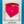 Neon pink heart-shaped suncatcher with a face design in a white box on a blue background