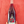 Bottle with a label featuring a person in a red outfit against a red background