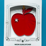 Red apple-shaped neon suncatcher in a decorative white box on a blue background