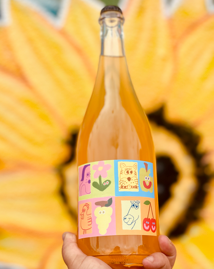 15% Orange Muscat 85% Gravenstein Organic Apples Lodi, California.  Woman winemaker - Cassidy Miller. All natural. Orange wine and cider co-ferment. This wine is down to clown, a flower field party for your mouth. Citrus medley and baked apple jamboree.