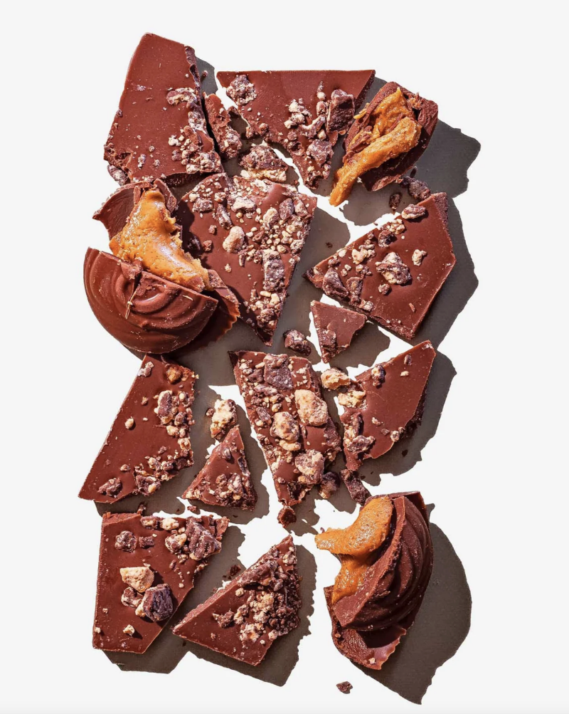Introducing our latest creation: the decadent Peanut Butter Cup chocolate bar. Indulge in Compartés peanut butter cups wrapped in creamy milk chocolate, in chocolate bar form. This is the most decadent marriage of peanut butter and chocolate. Featuring striking black and orange graphics, this is a modern twist on a classic that keeps you coming back for more... and more...