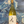 Wine bottle held in front of a stylized abstract background