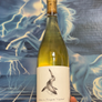 Wine bottle held in front of a stylized abstract background