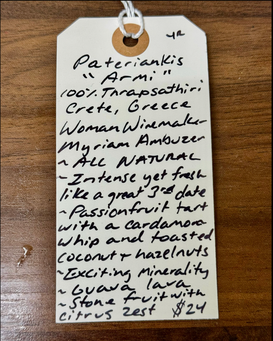 Handwritten wine label on a wooden surface