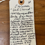 Handwritten label on a wooden surface with product details.