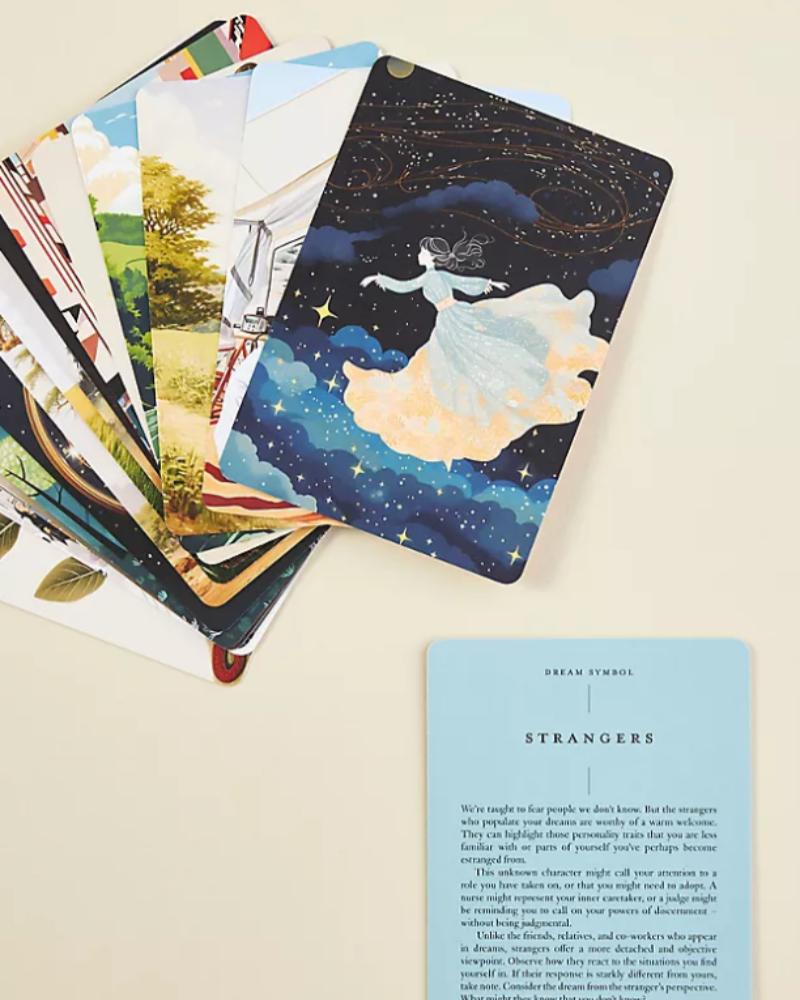 Collection of illustrated cards with a focus on one card featuring a woman in a dress against a starry night sky.