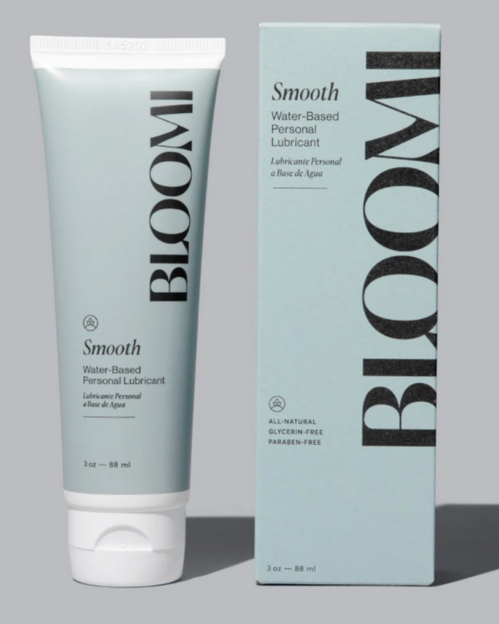 Tube and box of Bloom Smooth water-based personal lubricant on a gray background