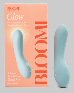 Bloomi Glow warming massager with packaging on a gray background